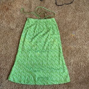 A long green skirt with waist strings at the top and white flowers.